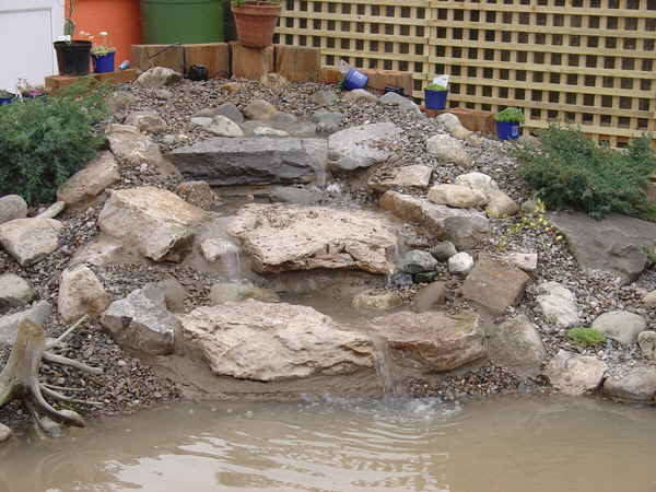 Waterfall integrated into a pond design